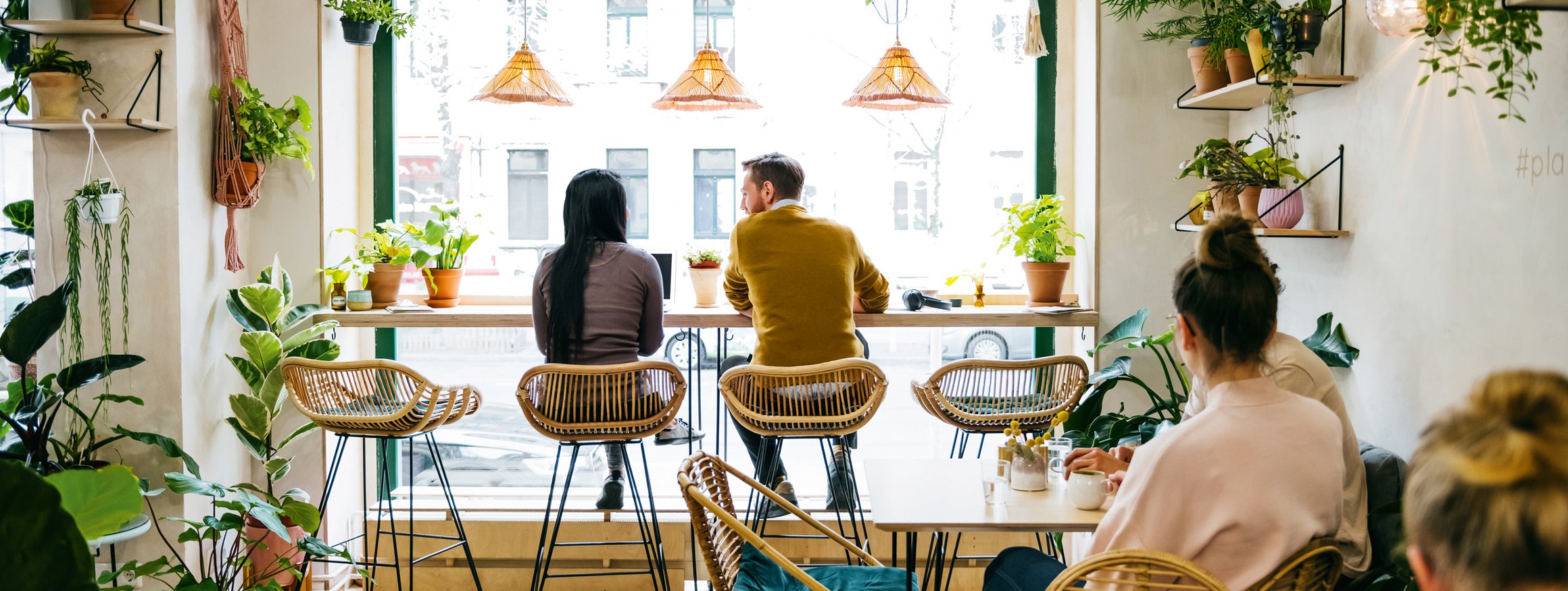 Mehrere Menschen sitzten in einem Café und genießen die Atmosphäre